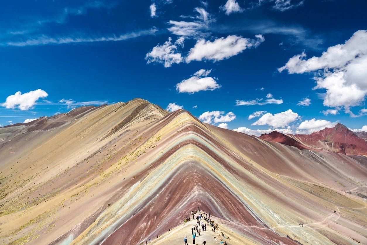 A group of people standing on top of a hill.